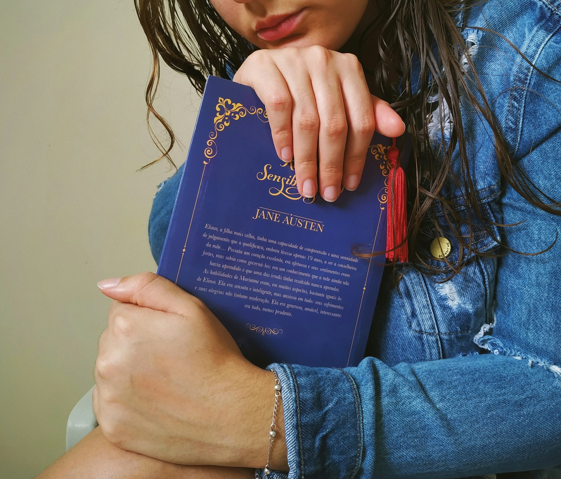 a woman holding a blue book in her arms